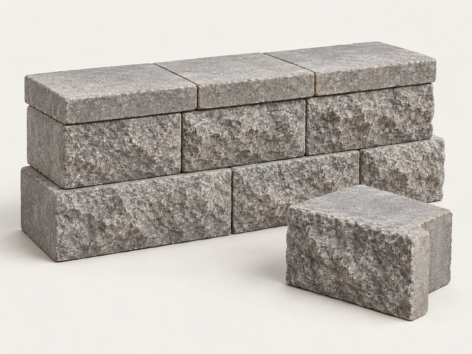 Split-face retaining wall blocks with flat capstones