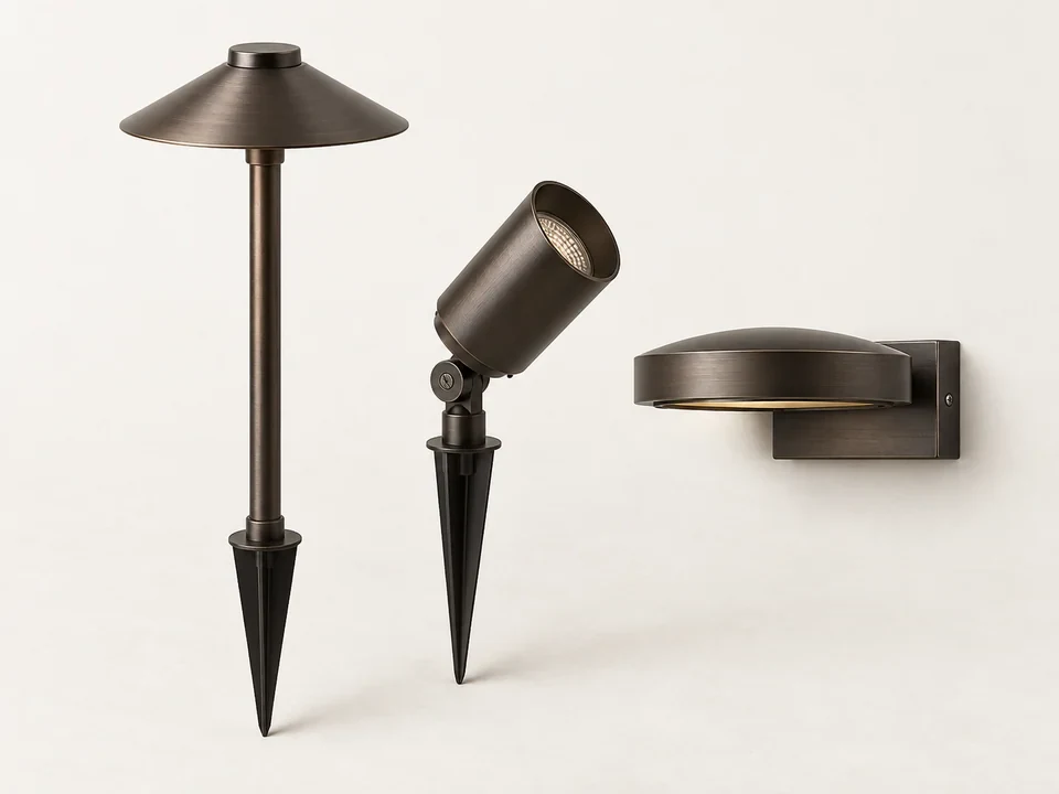 Alternate view of bronze pathway fixtures beside a garden walk in natural daylight
