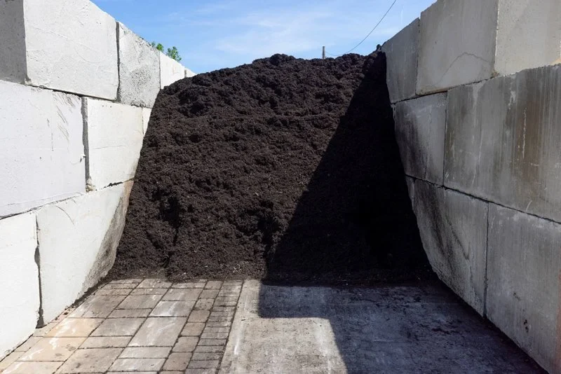 Bulk mulch in a concrete storage bay at Paver World