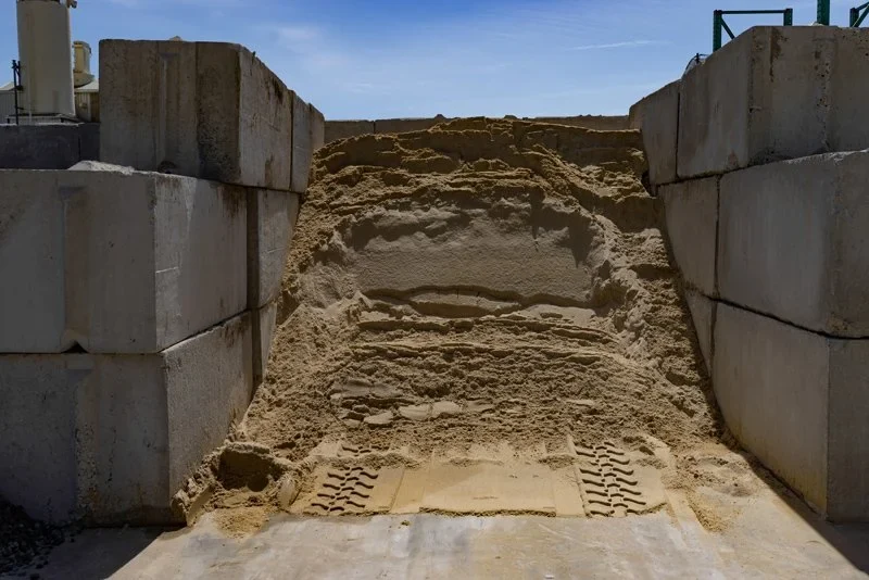 Bulk sand in a storage bay at Paver World