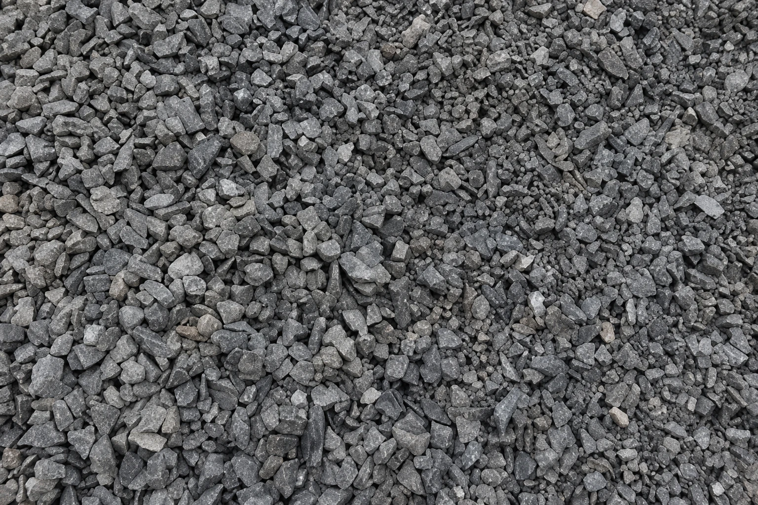Close-up of mixed-size dark gray QP crushed stone and fines