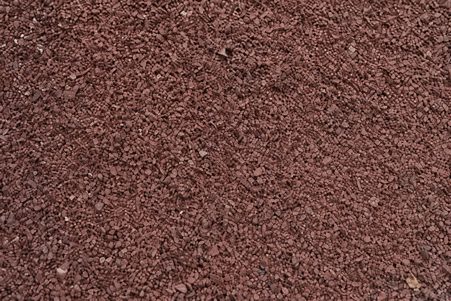 Fine angular reddish-brown crushed stone listed as 38 Red Stone